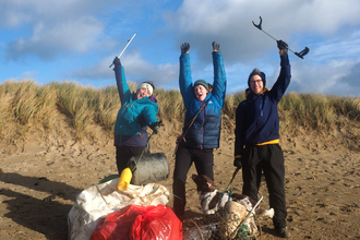 Plast off volunteers celebrating their haul of beach litter