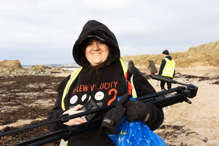 Beach clean youth forum volunteer out on the beach helping with filming equipment