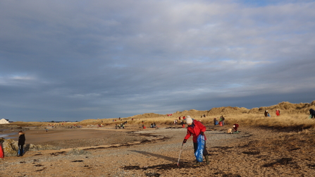 Porth Tyn Tywyn on Anglesey filled with many volunteer beach cleaners helping to clean the beach