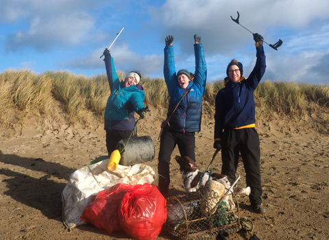 Image of three people celebrating at Plast Off beach clean event